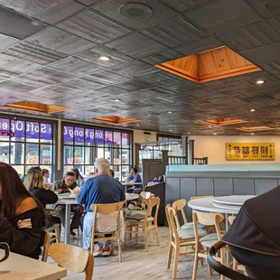 people sitting at tables and eating