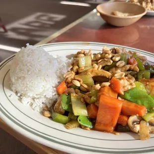 a plate of stir fried vegetables and rice