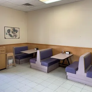 an empty restaurant with purple booths