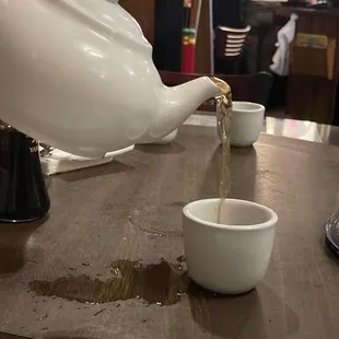 Pouring a cup of hot tea.