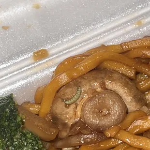 noodles and mushrooms in a styrofoam container