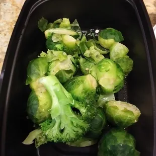 a bowl of broccoli on a countertop