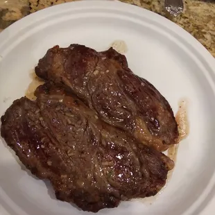 two steaks on a white plate