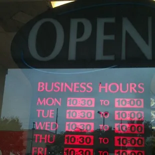 a business hours and hours sign