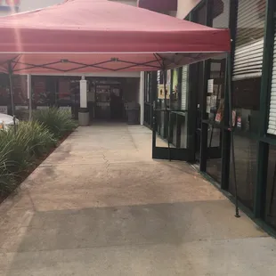 This tent is to keep customers cool while they wait outside in line/to pick up orders, since dining in is closed &amp; it's hot lately