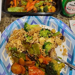 a plate of stir fried vegetables and rice
