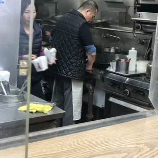 a man preparing food in a commercial kitchen