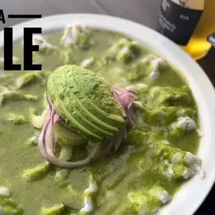 a bowl of guacamole and a plate of tortillas
