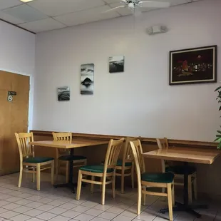 a dining area with tables and chairs