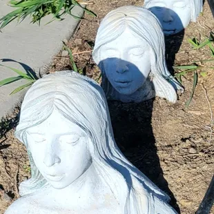 a row of statues of a woman&apos;s head