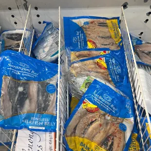 a display of fish in plastic bags