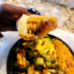a hand holding a piece of food
