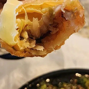 a person holding a piece of food