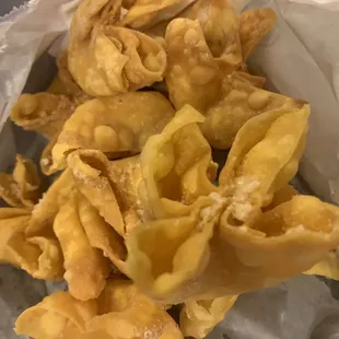 a pile of wontons in a paper bag