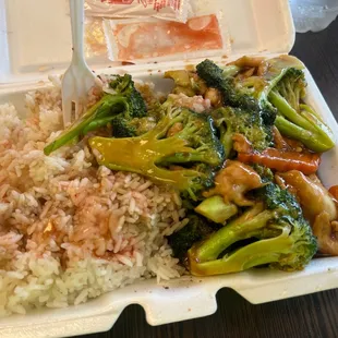 rice, broccoli, and chicken in a styrofoam container