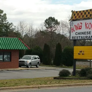 two cars parked in front of the restaurant
