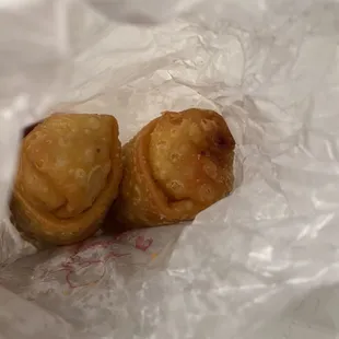 two pastries wrapped in plastic