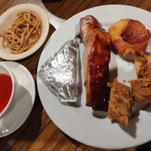 Hong Kong Nest Appetizer includes paper wrapped chicken, spare ribs, bacon wrapped shrimp, cream cheese wonton and chicken egg rolls.