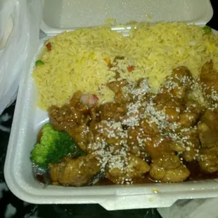 a takeout box with rice, broccoli, and meat