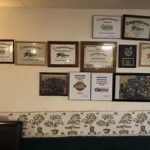 a wall full of certificates