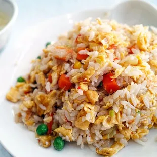 a plate of fried rice and vegetables