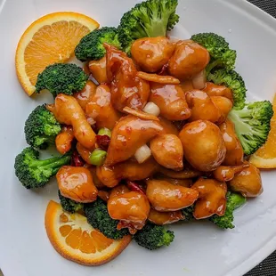 broccoli and oranges on a white plate