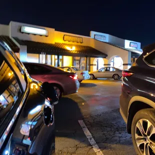 cars parked in a parking lot at night