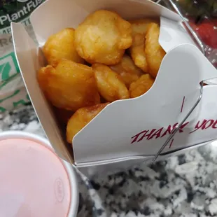 a take out box of fried food