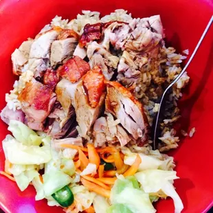 a bowl of rice, meat and vegetables