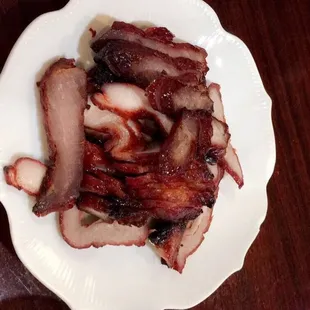 a plate of sliced meat on a table
