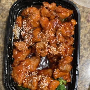 a container of chicken and broccoli