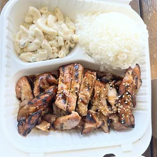 Chicken teriyaki with salad and rice and macaroni salad.