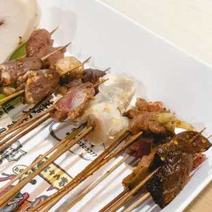 a variety of skewers on a plate