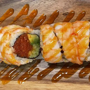 a sushi roll with shrimp and avocado