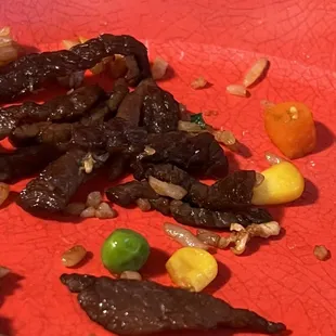 a red plate with food on it