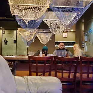 a man and a woman sitting at a bar