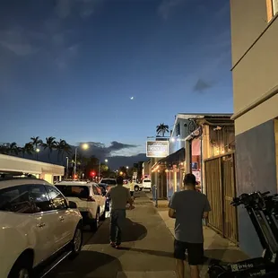 a man walking down a street at night