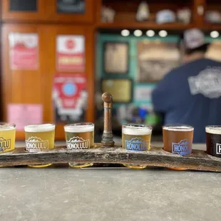 a flight of beers on a bar