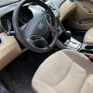 Dirty and stained driver's seat and space