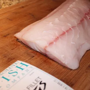 a piece of fish on a cutting board