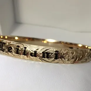 A closer look at the black enamel lettering placed over the "wild maile" scroll design.