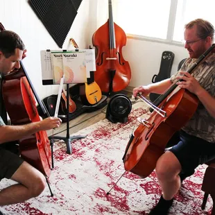 Benjamin Perry with student teaching a cello lesson