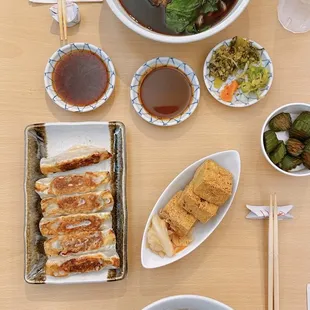 Beef noodle soup, gyoza, crispy tofu, pickled cucumbers, sesame dry noodles