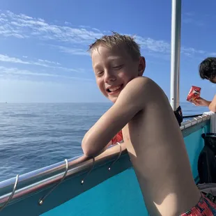 My son enjoying the boat after snorkeling.