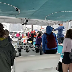 Heading off the boat after a rainy whale watching tour
