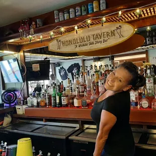 a woman standing in front of the bar