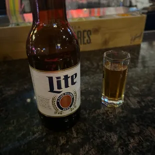 a glass of beer and a lite bottle