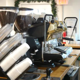 a coffee machine and cups on a counter