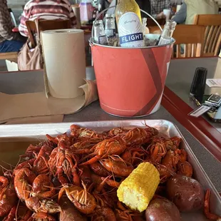 a tray of craws, potatoes, and corn