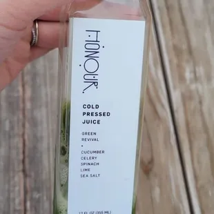 a hand holding a bottle